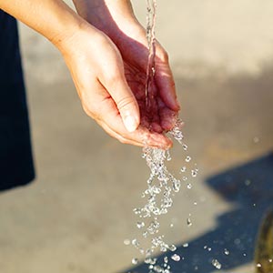 water flowing over a person's hands